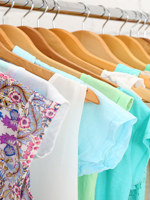 women's clothing hanging on wooden hangers 